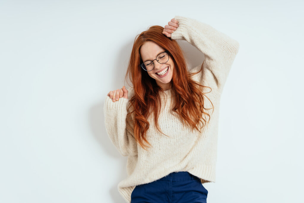 Patient celebrating her available dental benefits.
